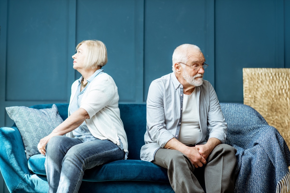 man and woman turned away from each other on a couch