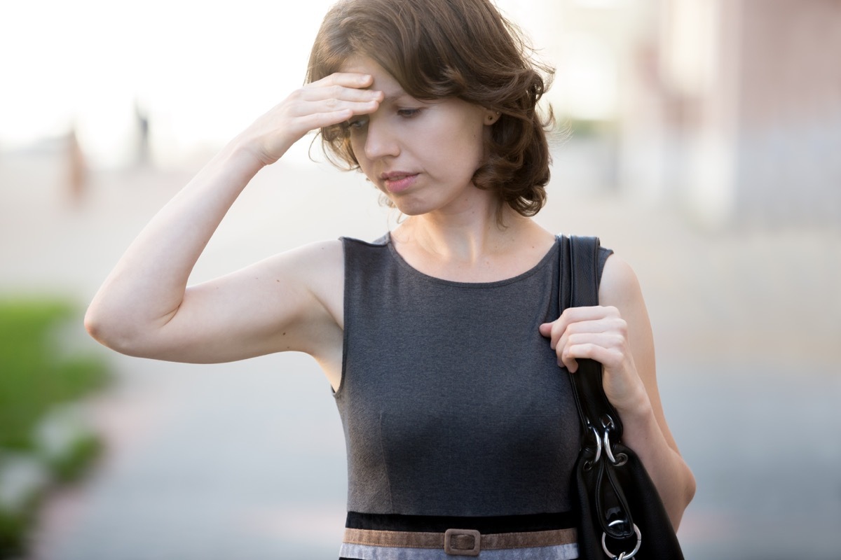 Woman on the Street Holding Her Head and Feeling Dizzy Heart Attack Signs