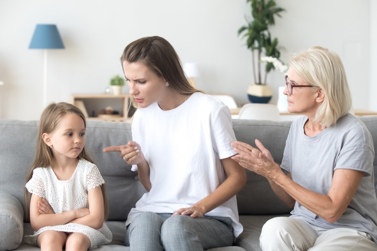 Mother disciplining her daughter with grandmother there