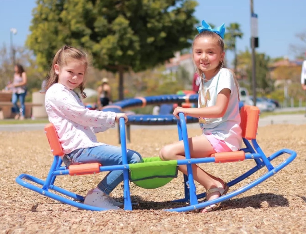 two children sitting in blue seesaw, best outdoor toys for toddlers