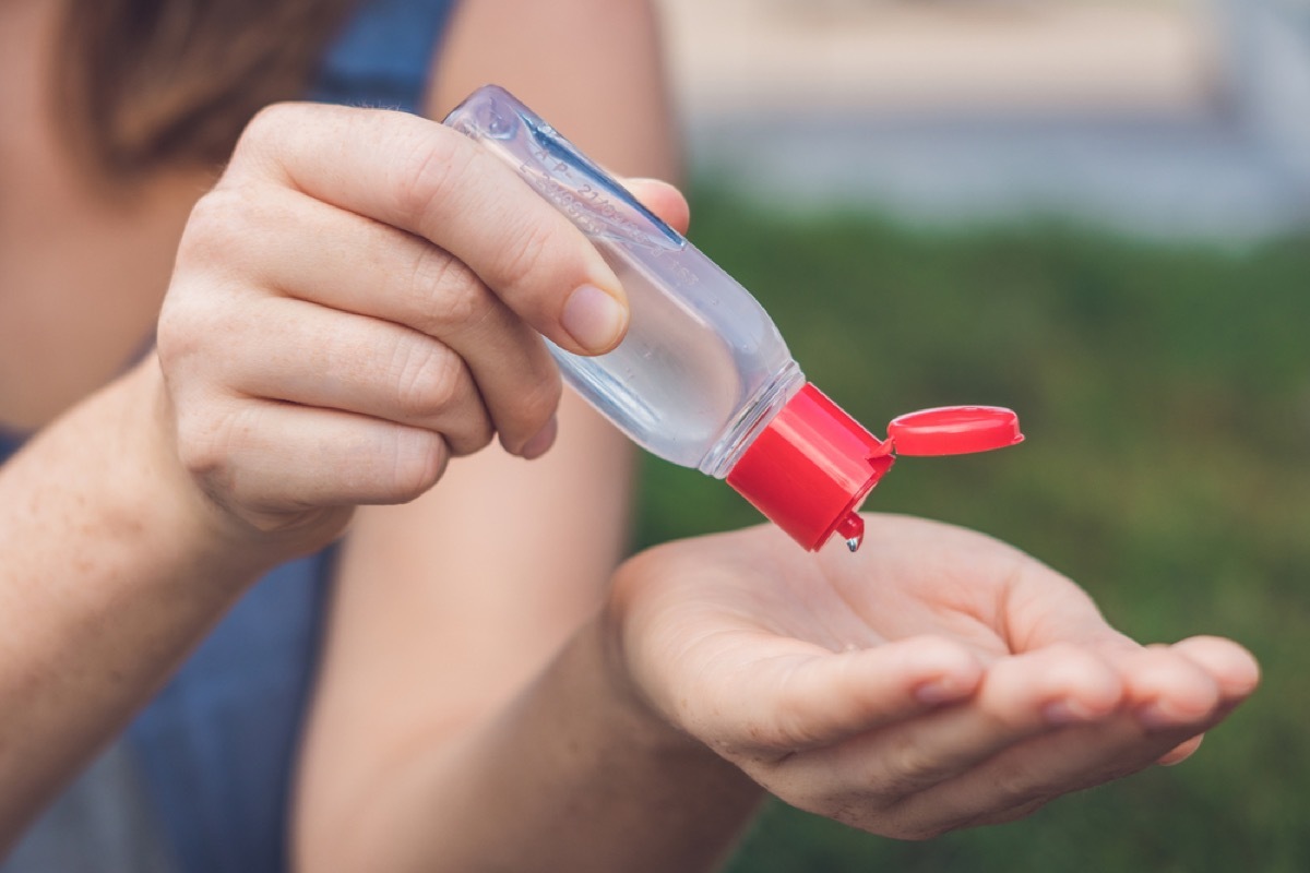 woman using hand sanitizer ways we're unhealthy