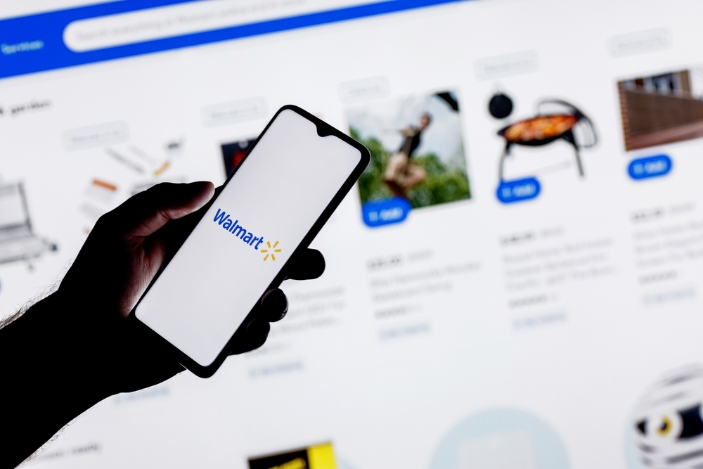 A close up of a person using their smartphone to shop on the Walmart website or app