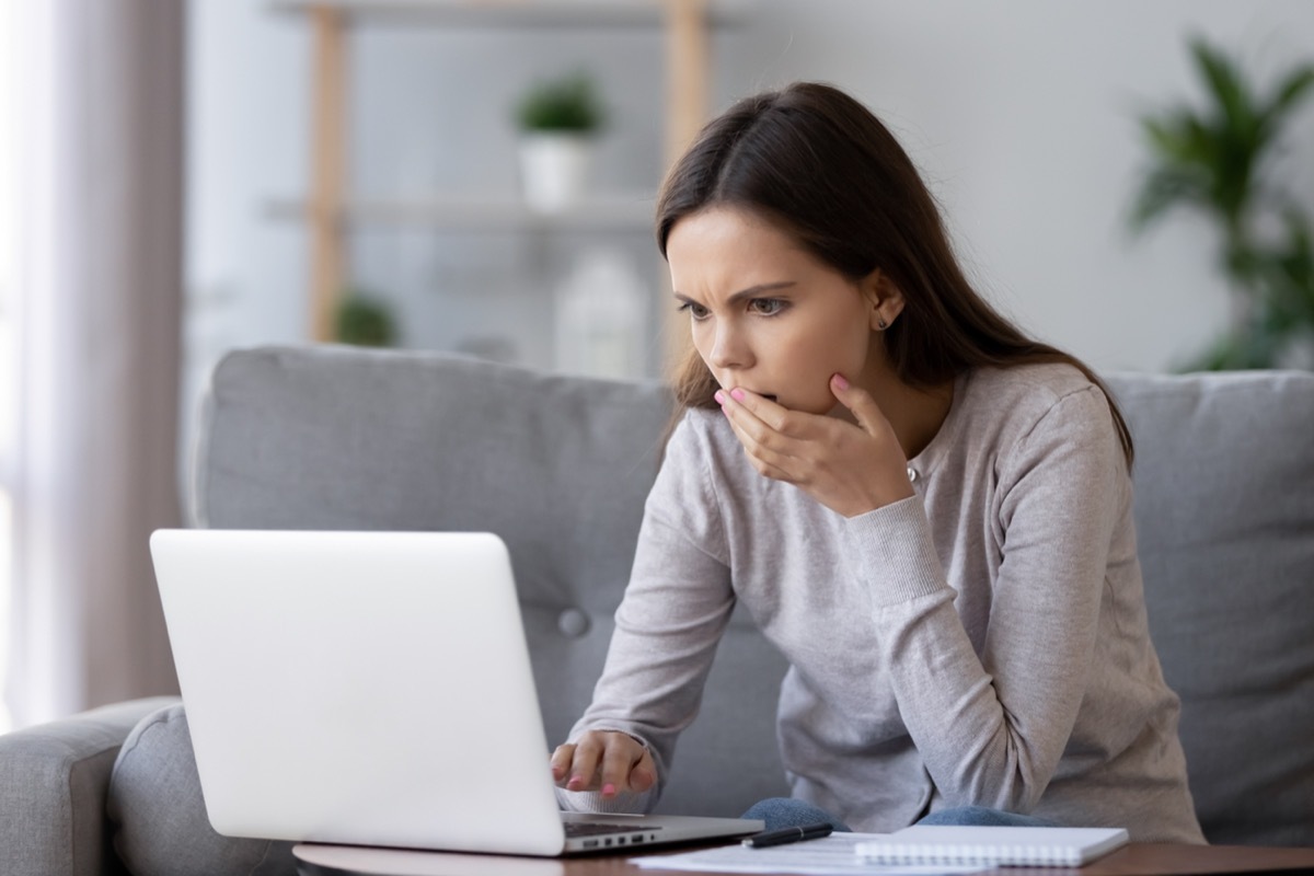 woman looking shocked at computer