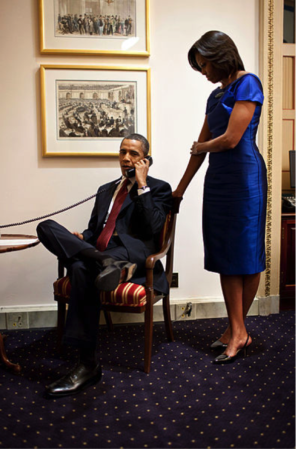 President Obama and Michelle Obama making a call in the White House