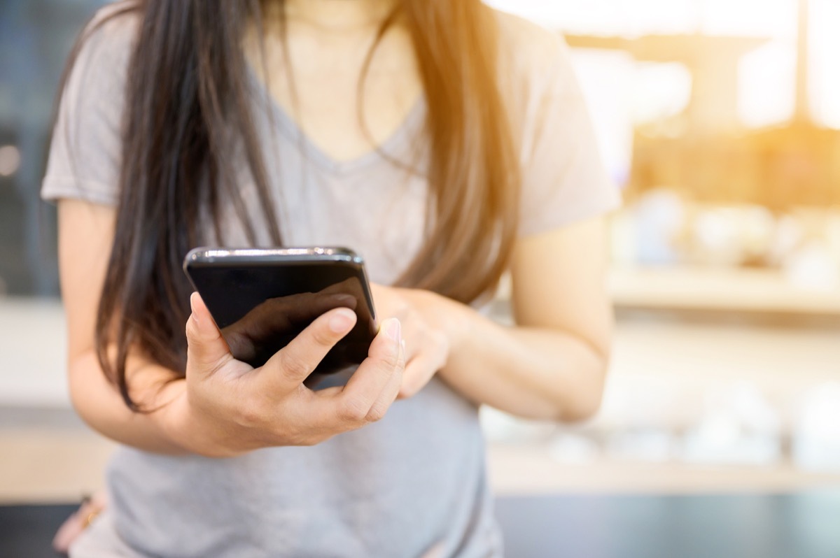 Close up image of woman using her mobile smartphone