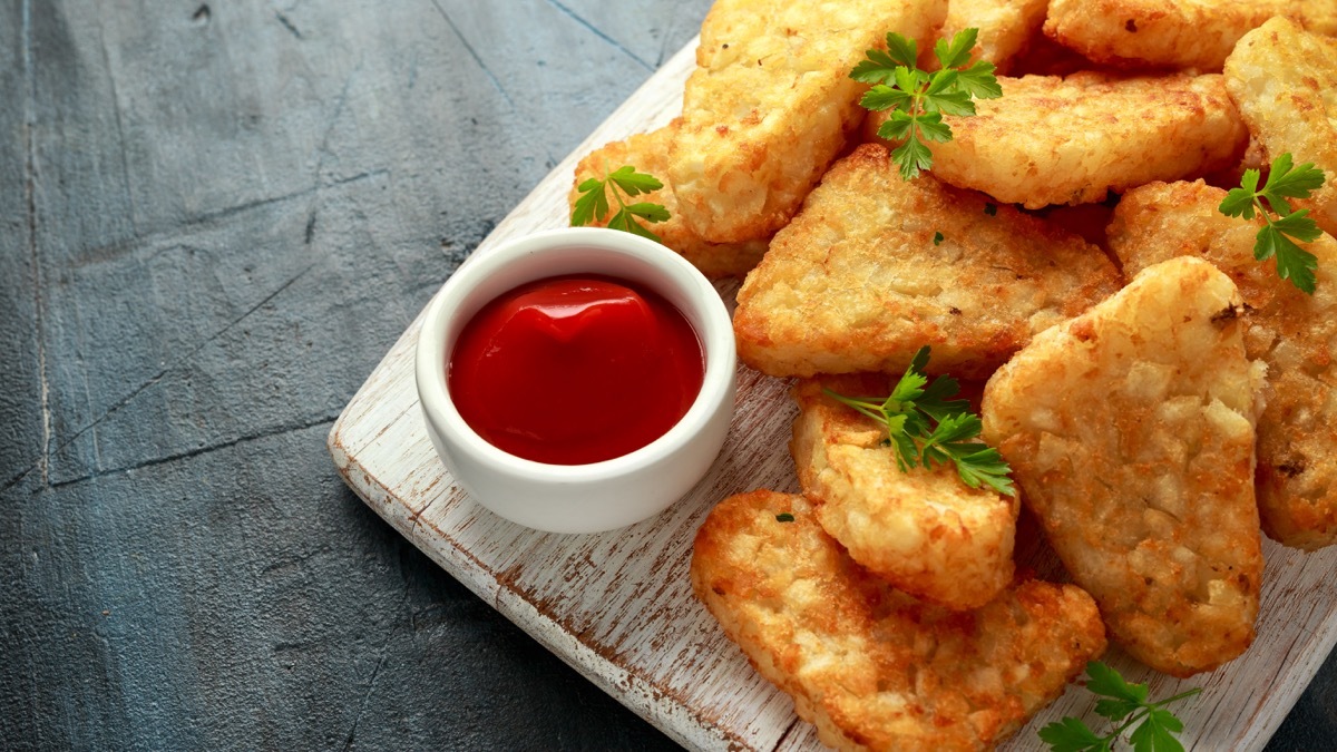 hash browns on wooden board, ketchup