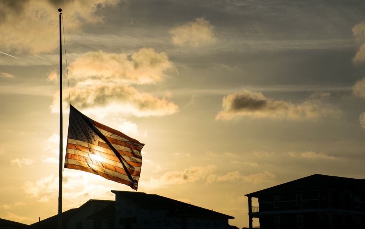 flag at half staff at sunset