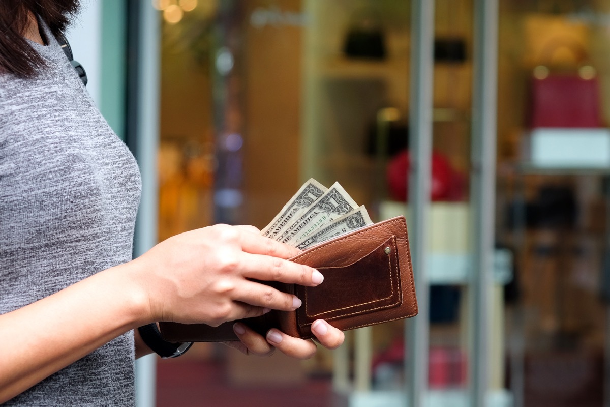 woman with dollar bills in wallet