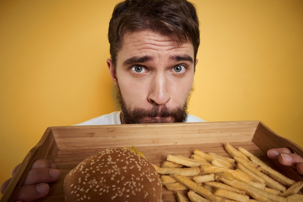 man eating burger