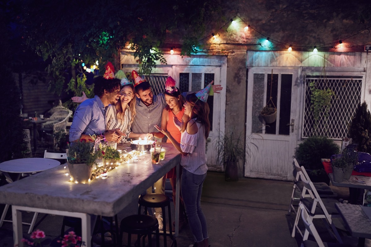 group of adult friends celebrating a birthday party