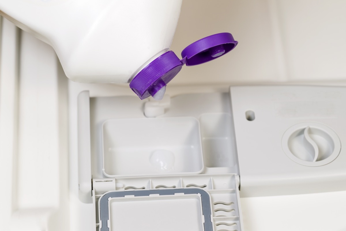 Horizontal photo of detergent being poured into dishwasher soap dispenser