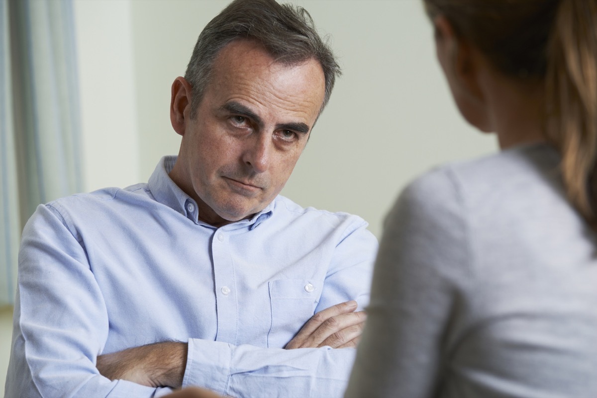 Depressed Mature Man looks angry with arms crossed