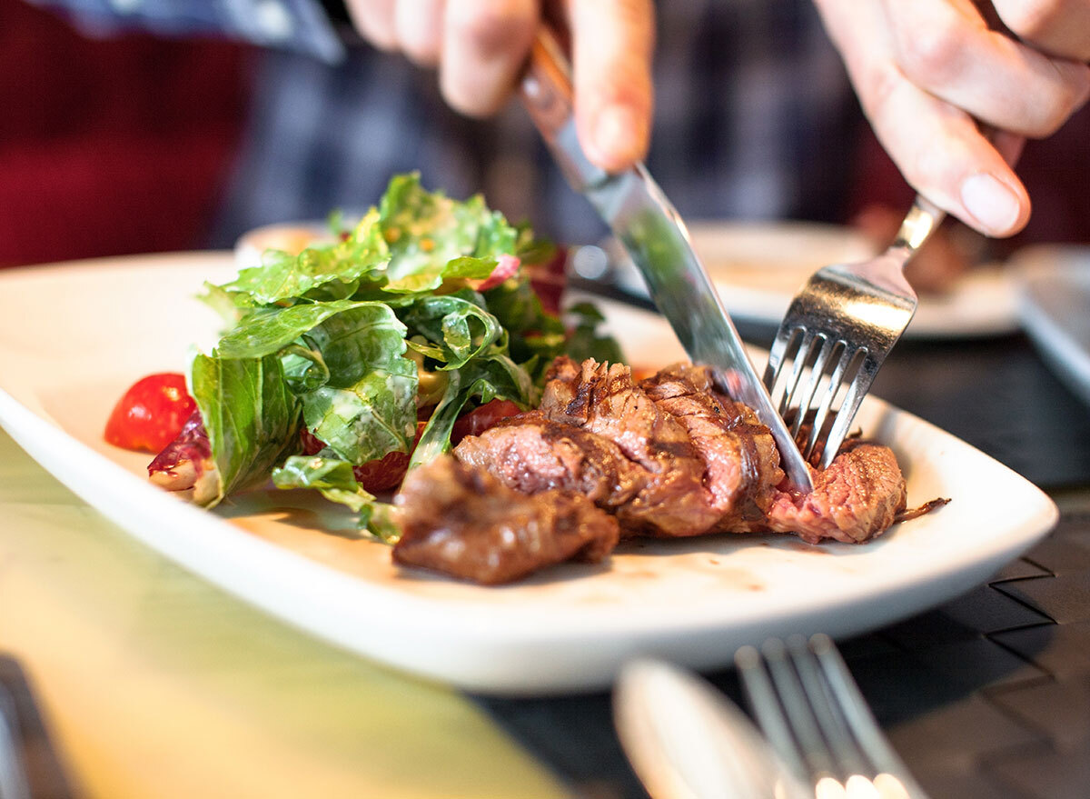 man eating steak