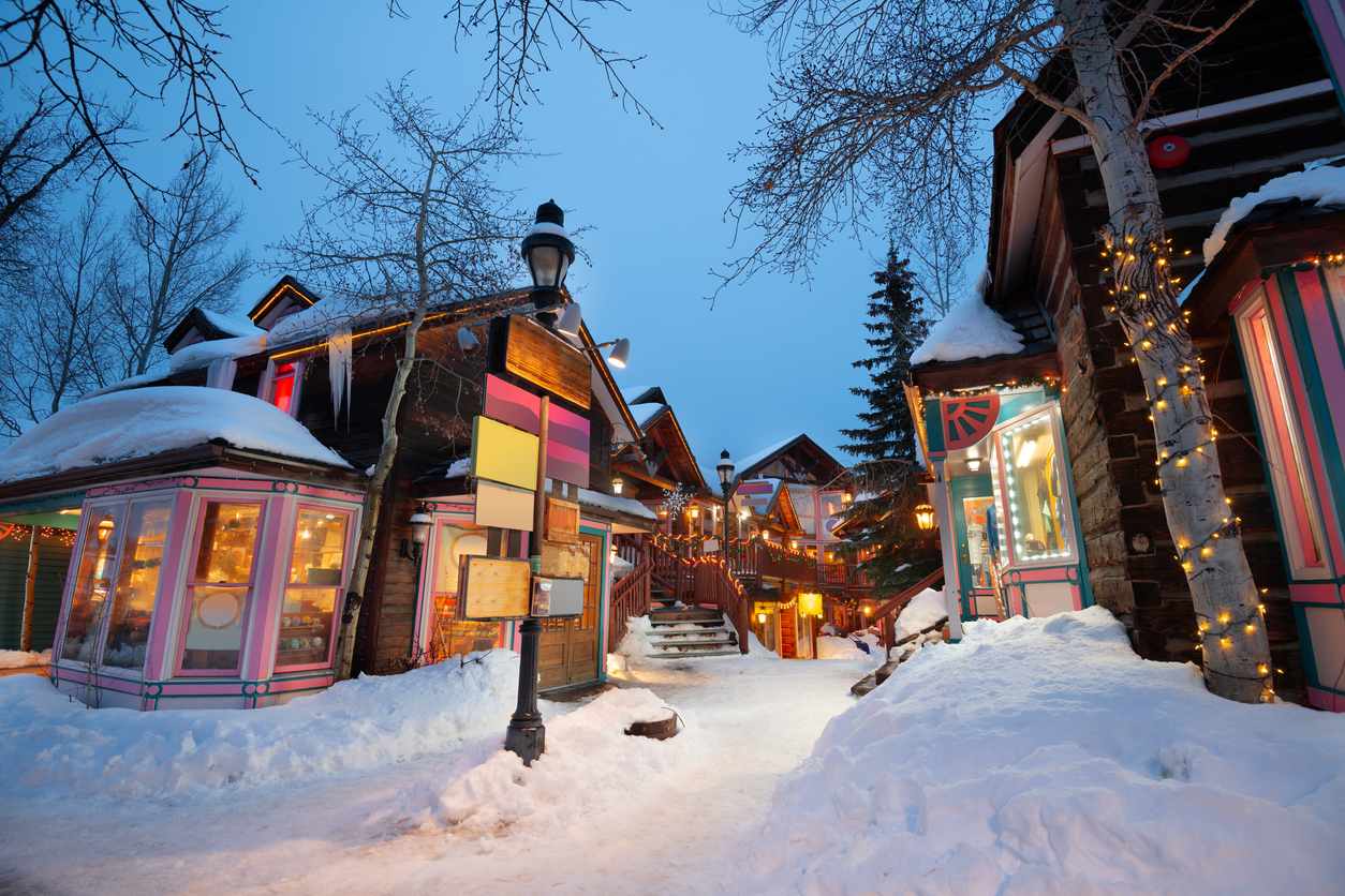 Breckenridge, Colorado, USA downtown streets at night in the winter with holiday lighting.