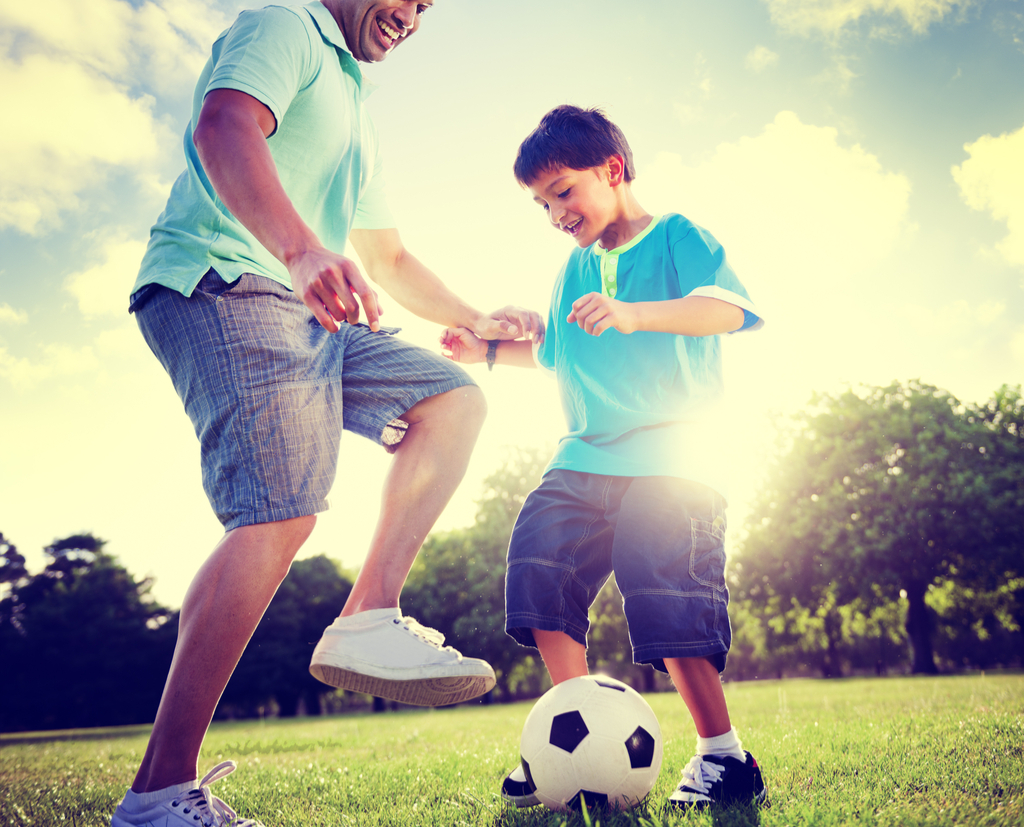 Father and Son Playing Soccer Parenting