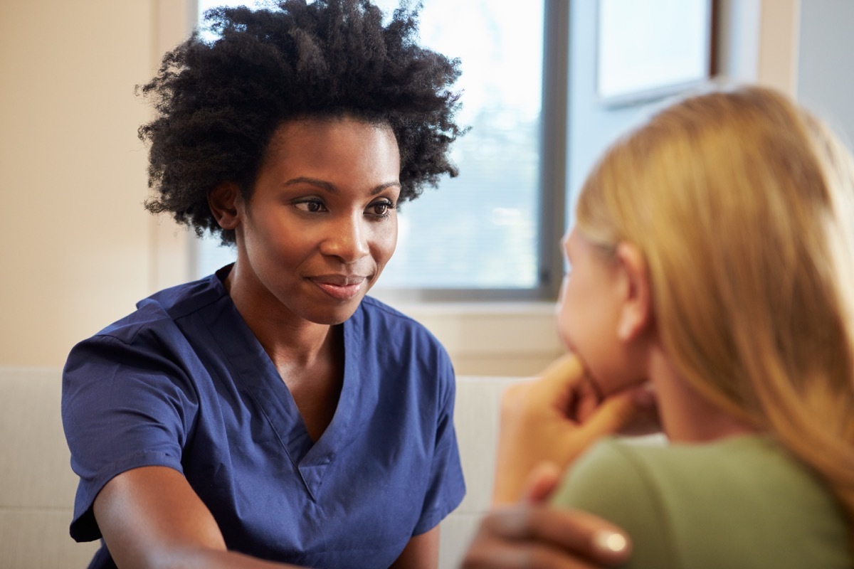 Nurse Treating Teenage Girl Suffering With Depression