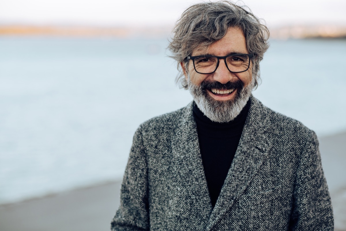 Portrait of a happy mature man posing on the beach.