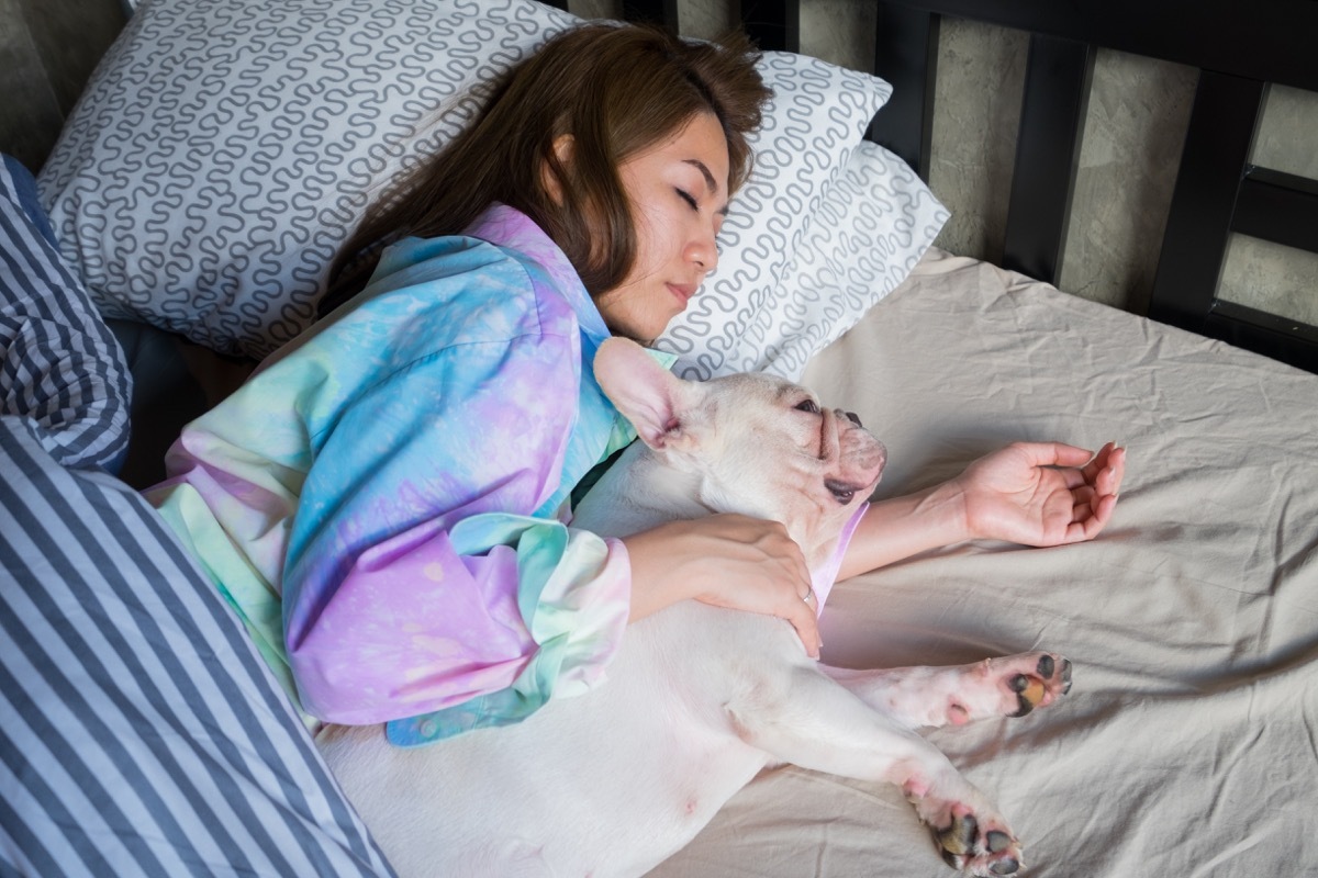 woman sleeping with dog