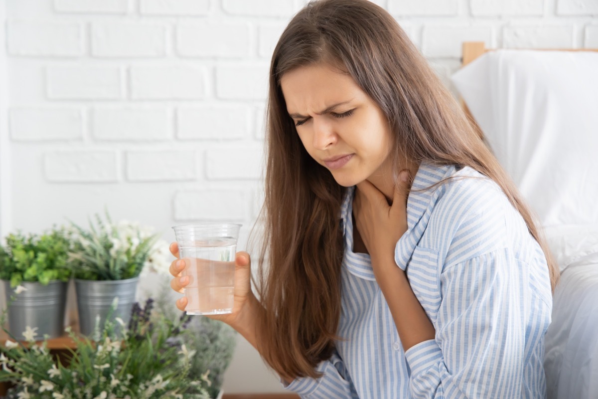 choking woman while drinking water;