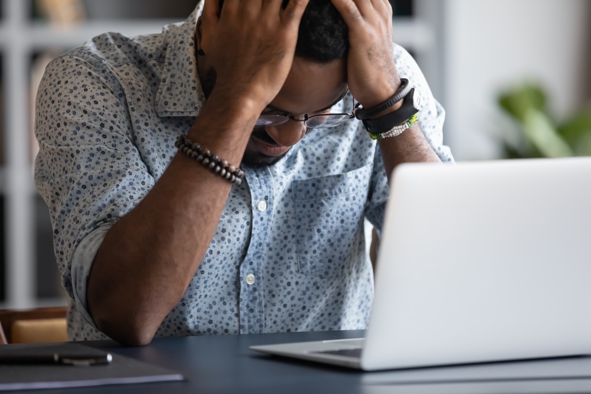 Man in Emotional Distress by his Laptop