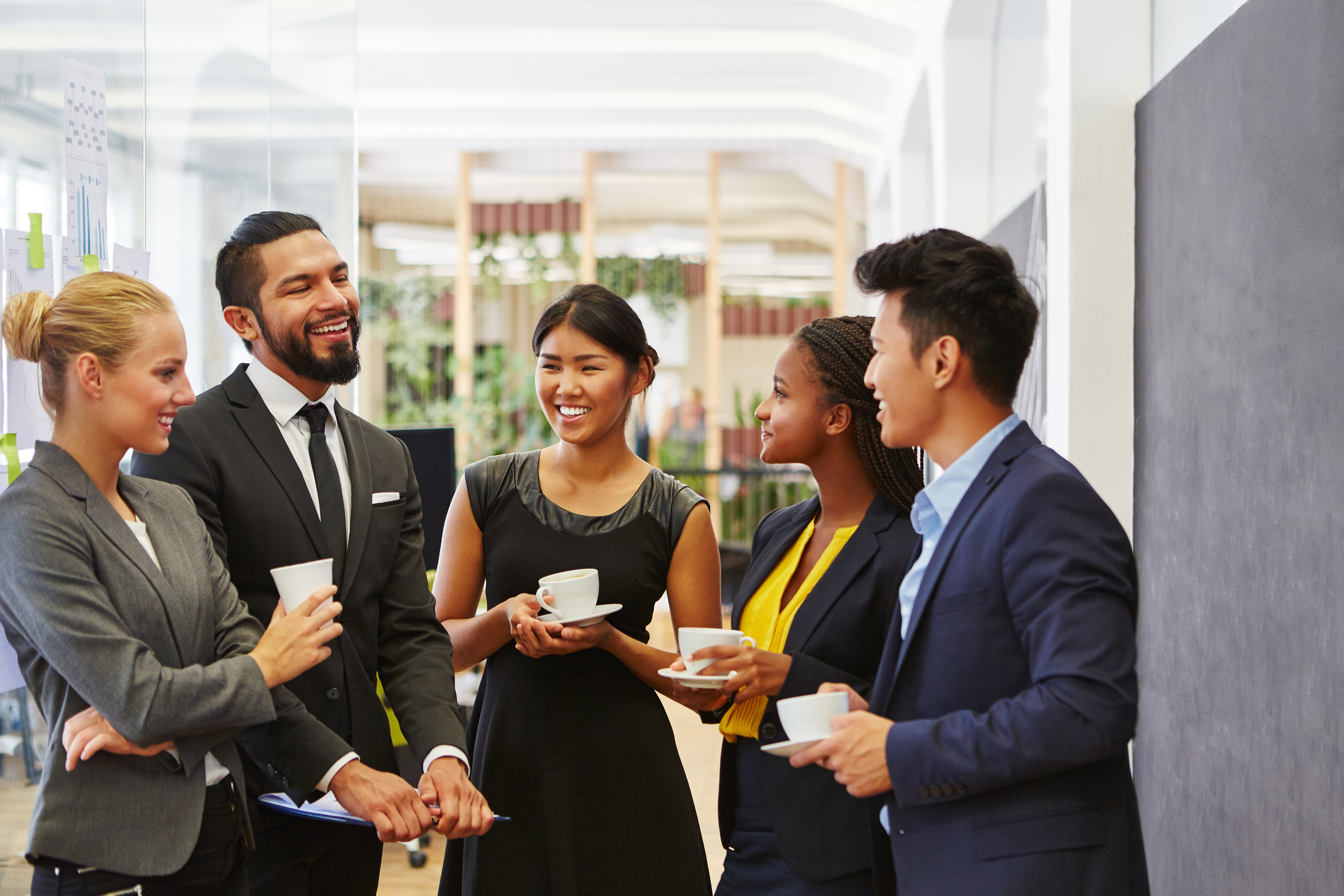 group of coworkers standing around and making small talk