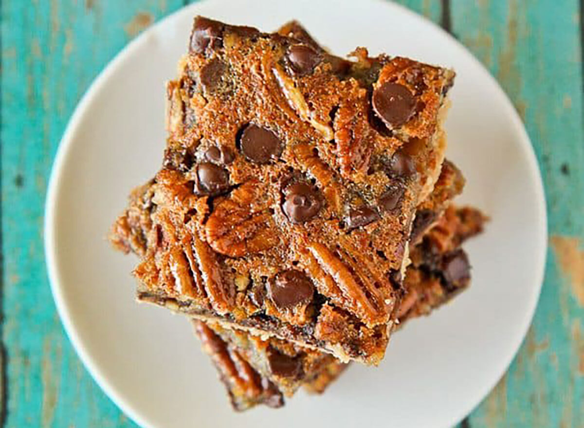 chocolate chip pecan pie bars on white plate