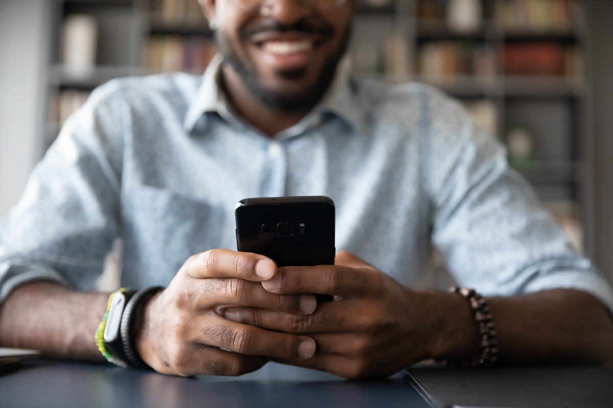 man reading i miss you messages on his phone from his girlfriend