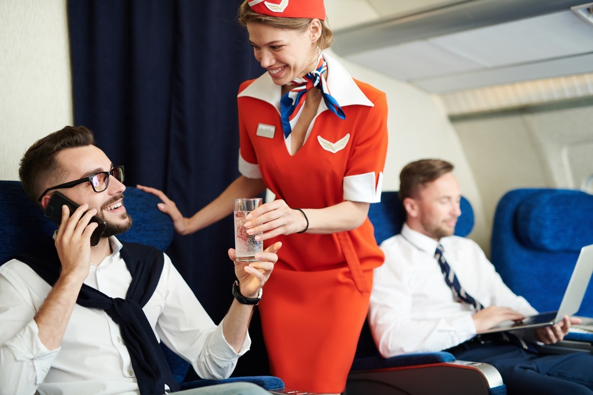 flight attendant talking to man on airplane things that horrify flight attendants