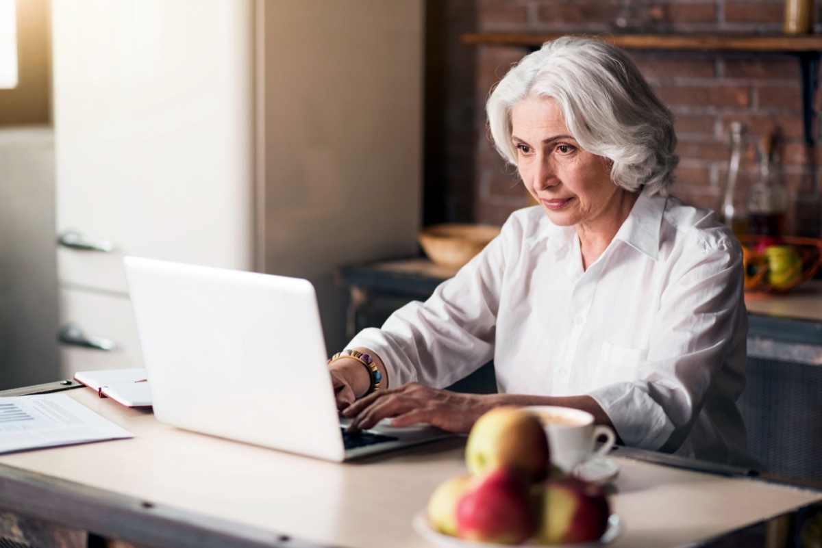 older woman looking at laptop