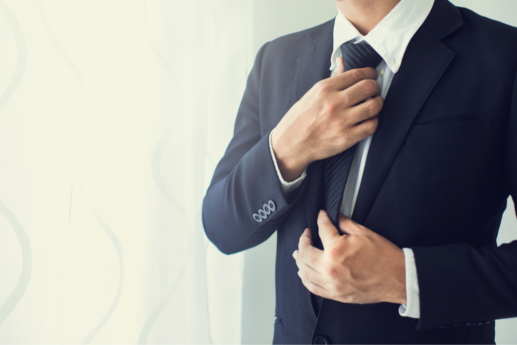 Man Fidgeting with Suit Body Language That Kills First Impressions