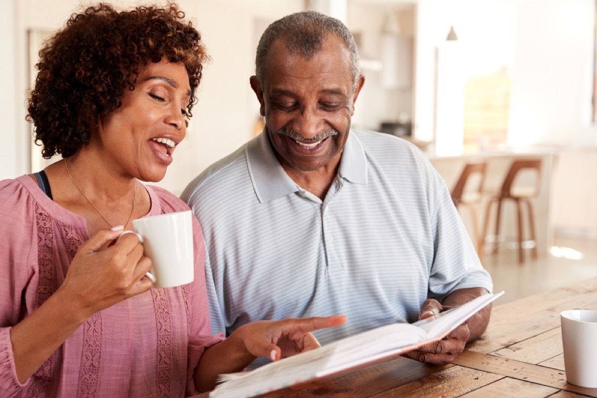 couple looking through photo album over coffee