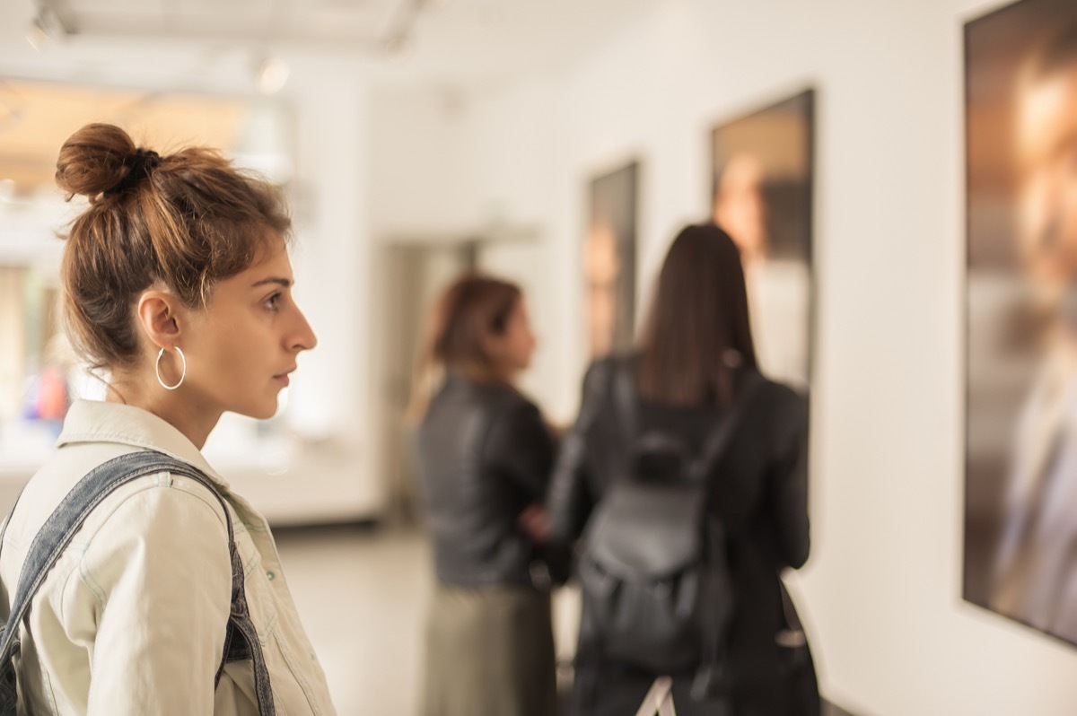 Woman looking at painting