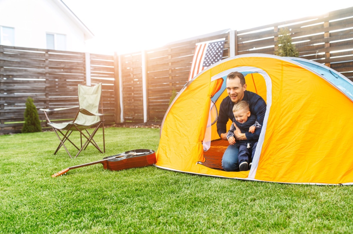 Father and son camping in the backyard