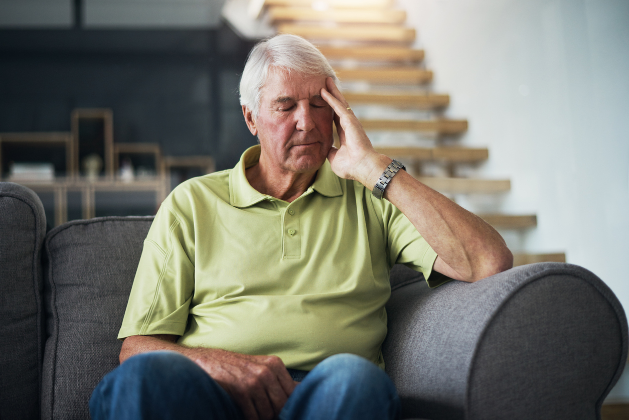 Senior man not feeling well at home.