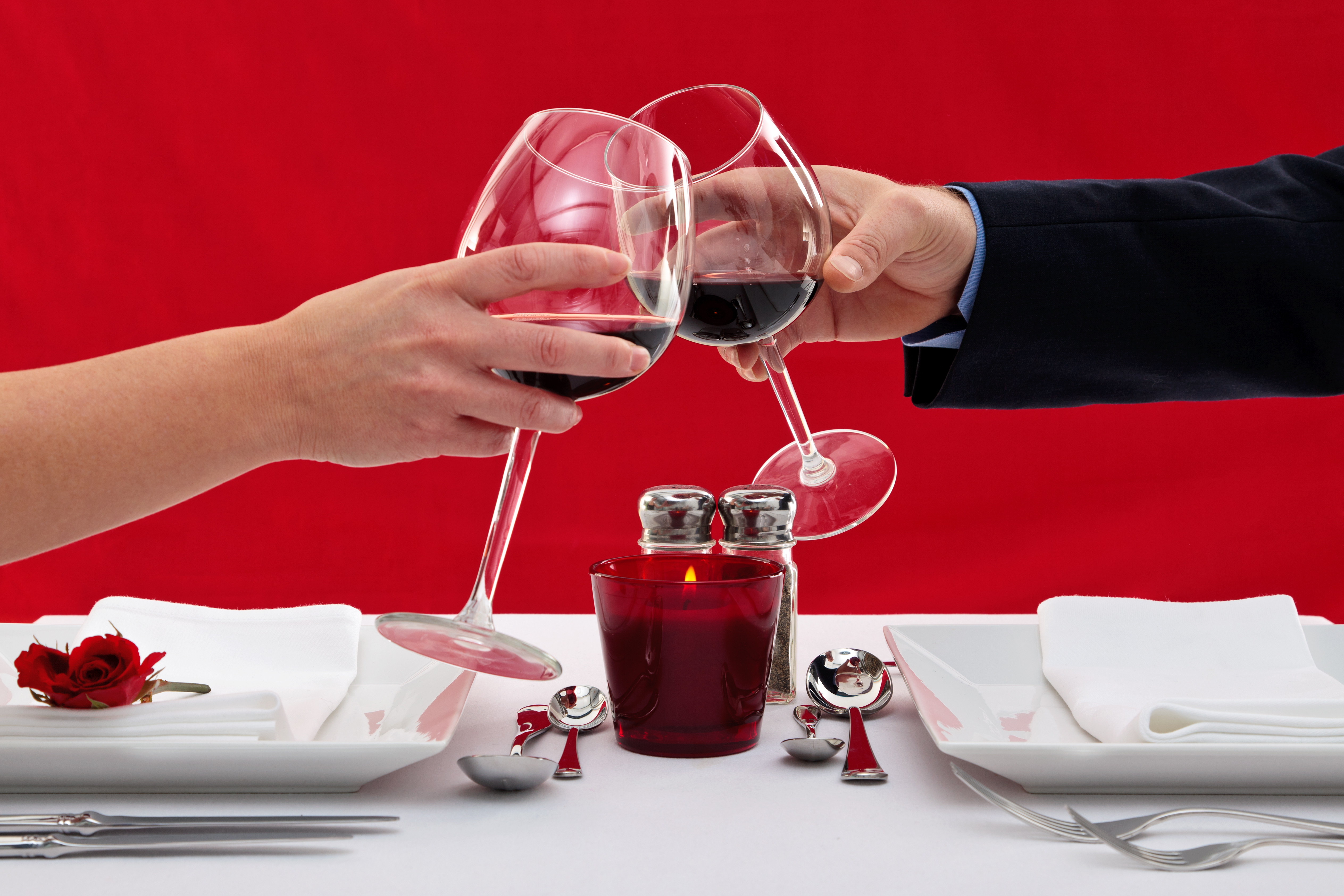 couple drinking red wine during a romantic dinner