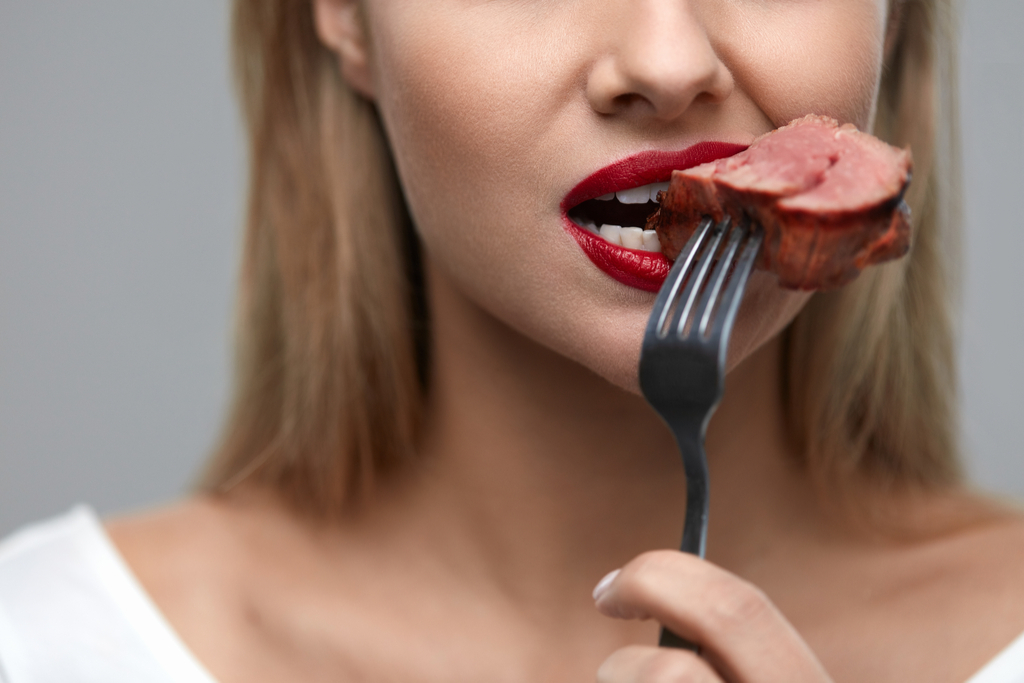 Woman Eating Steak