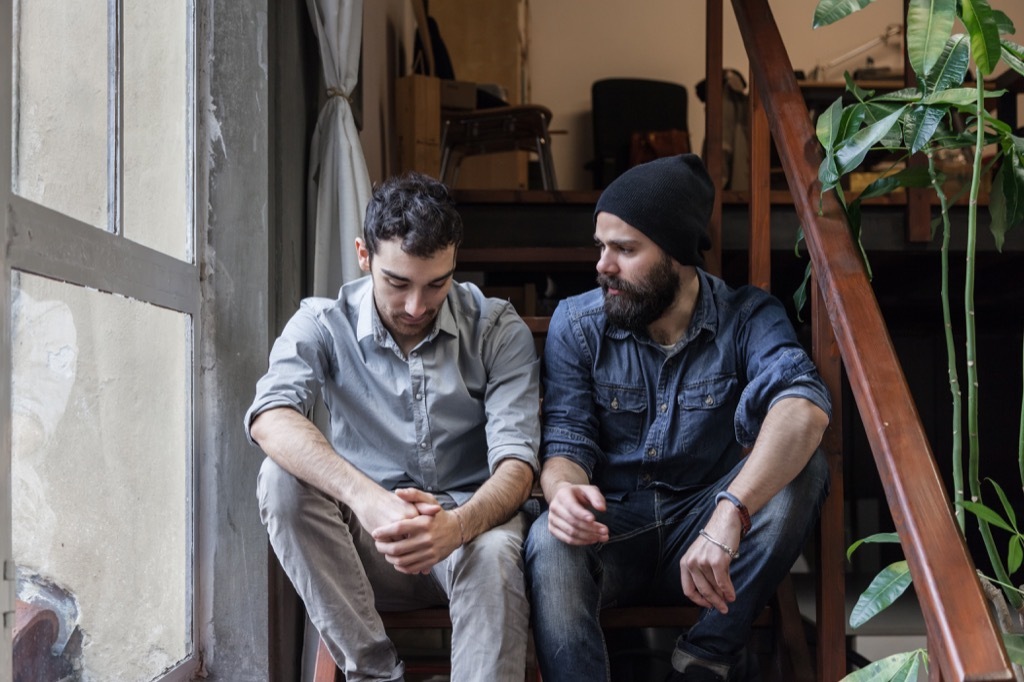 two friends talking on the stairs