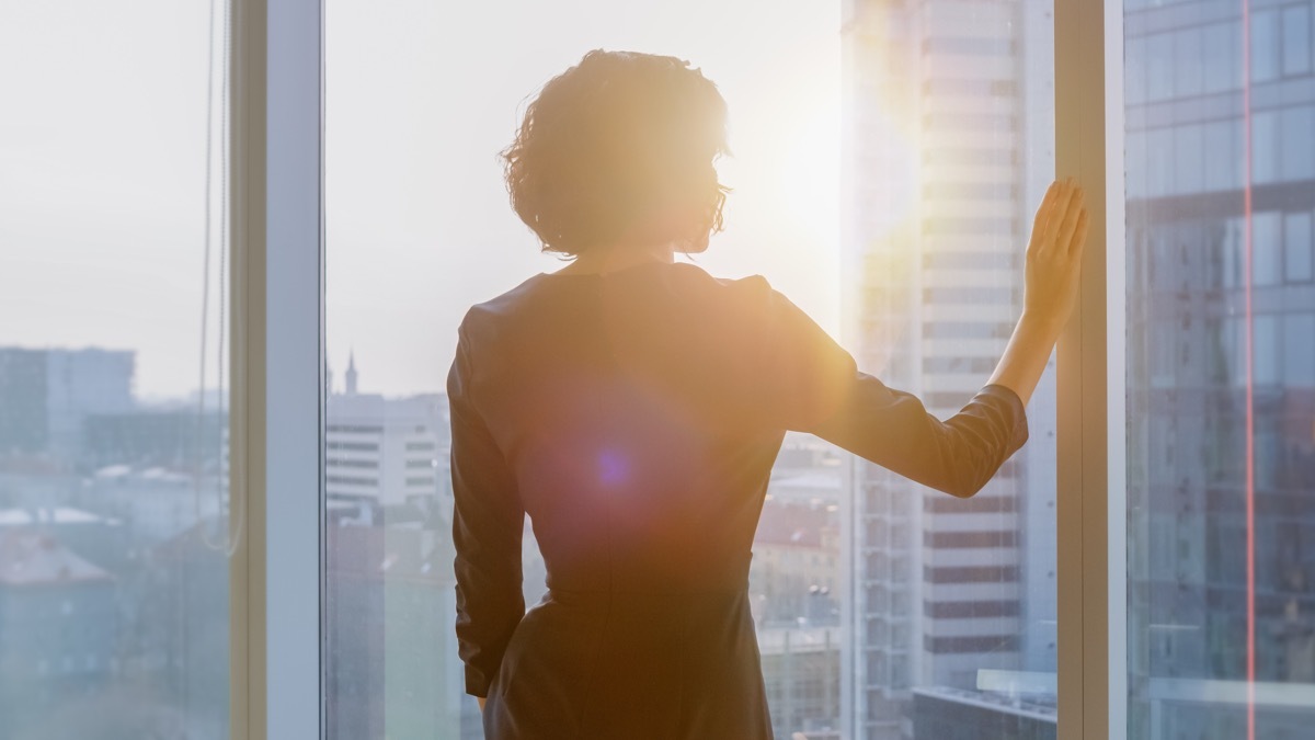 businesswoman looking out of window