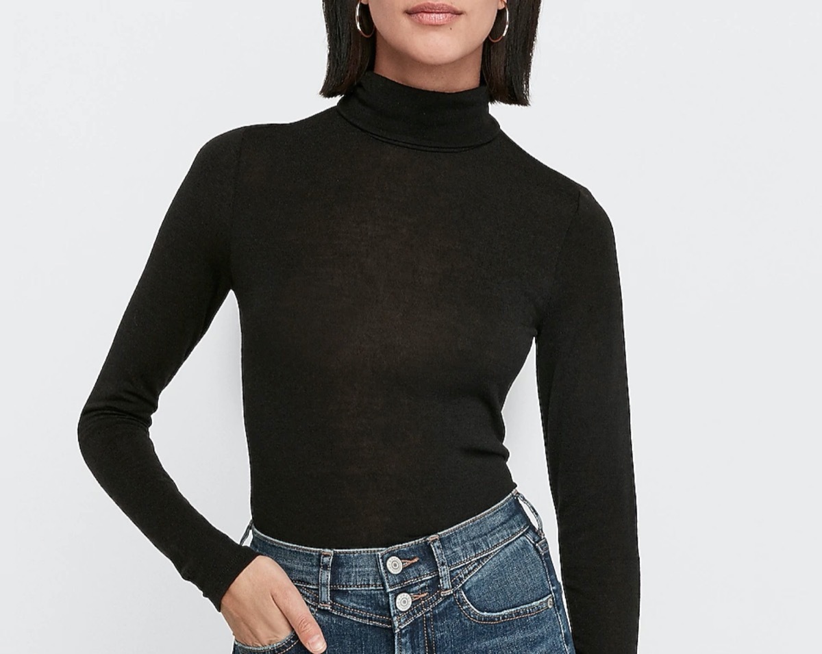 young woman in black turtleneck and jeans