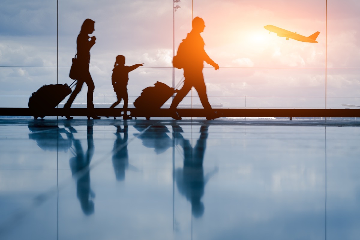 Silhouette of young family and airplane