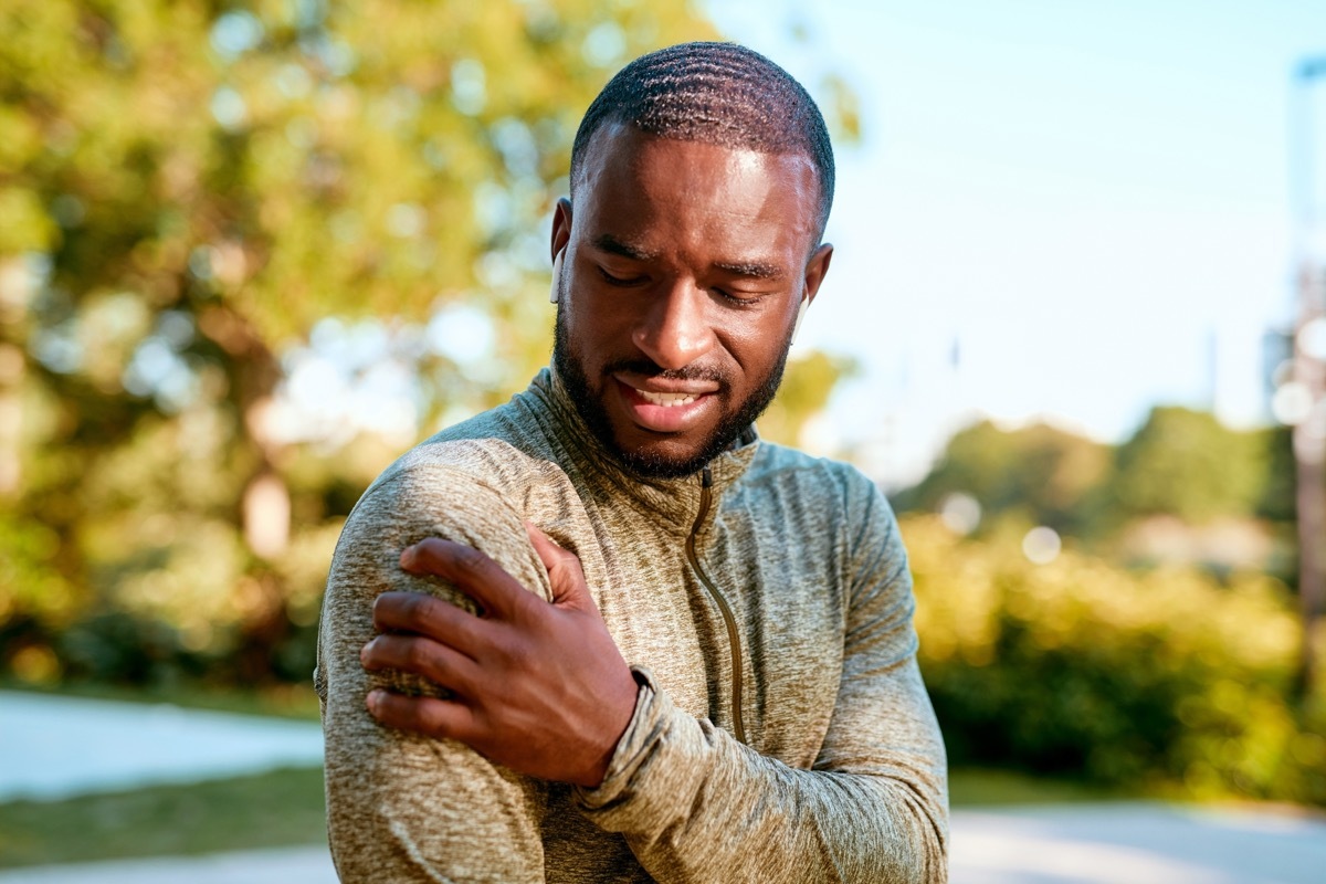 Shot of a sporty young man suffering from a sports injury outdoors