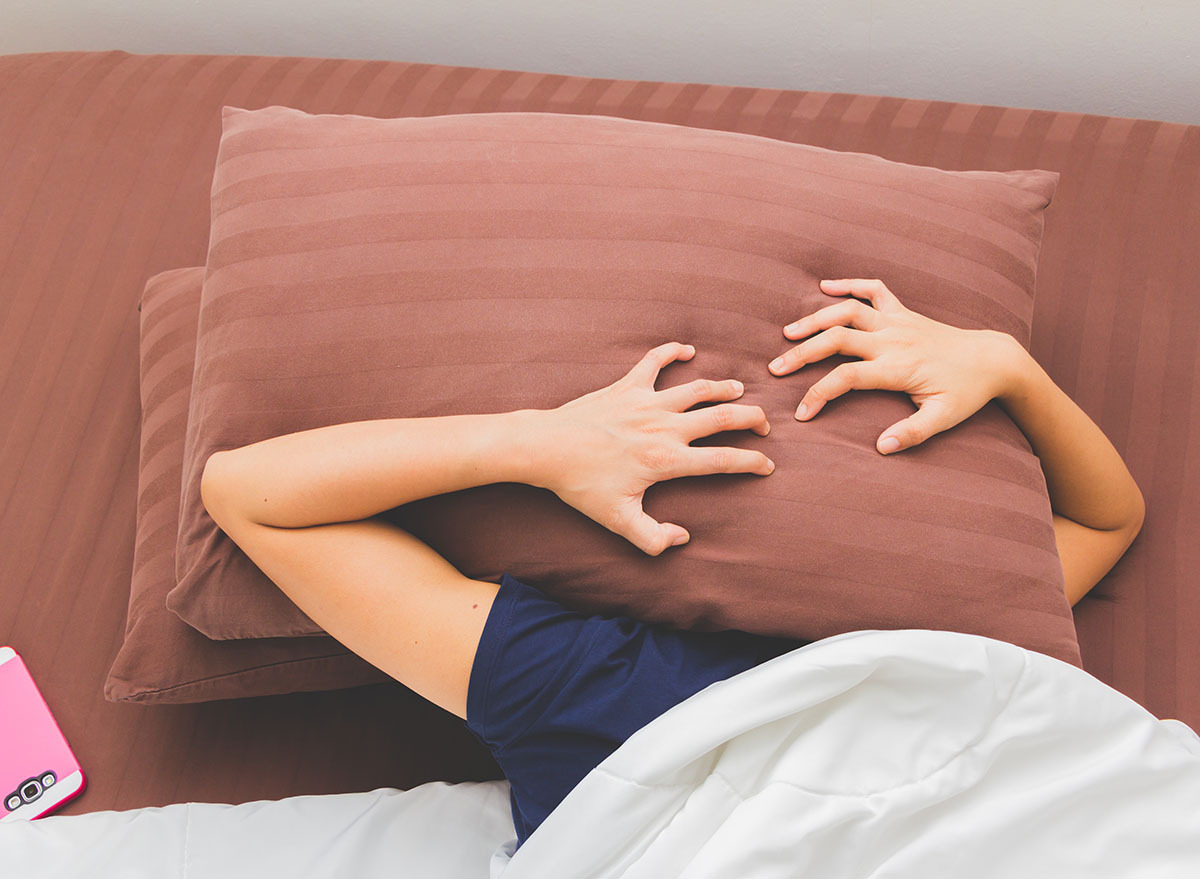 woman cannot sleep with two pillows over face