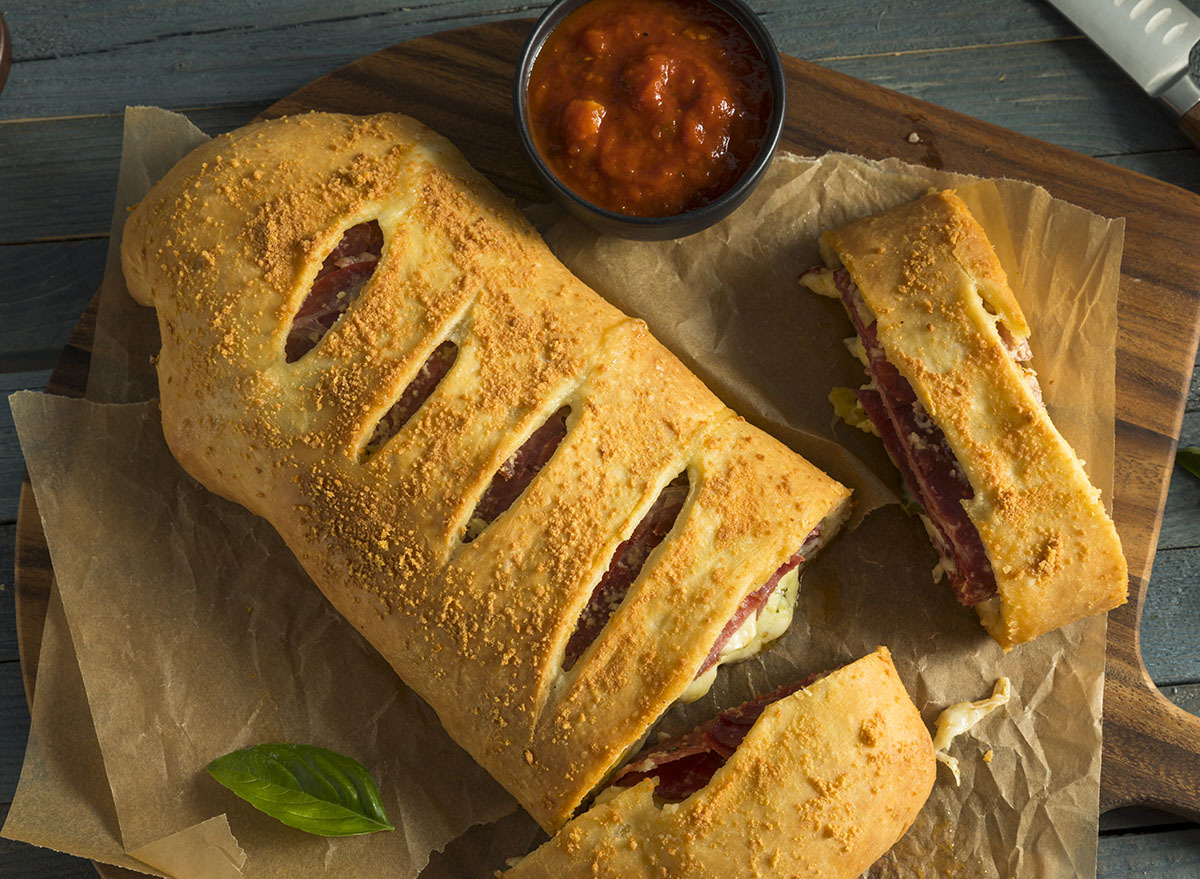 meat stromboli on wood cutting board