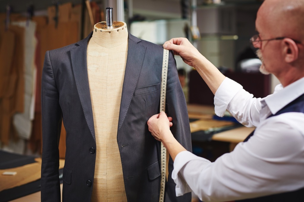 tailor measuring a blazer with tape measure - how to dress over 50 