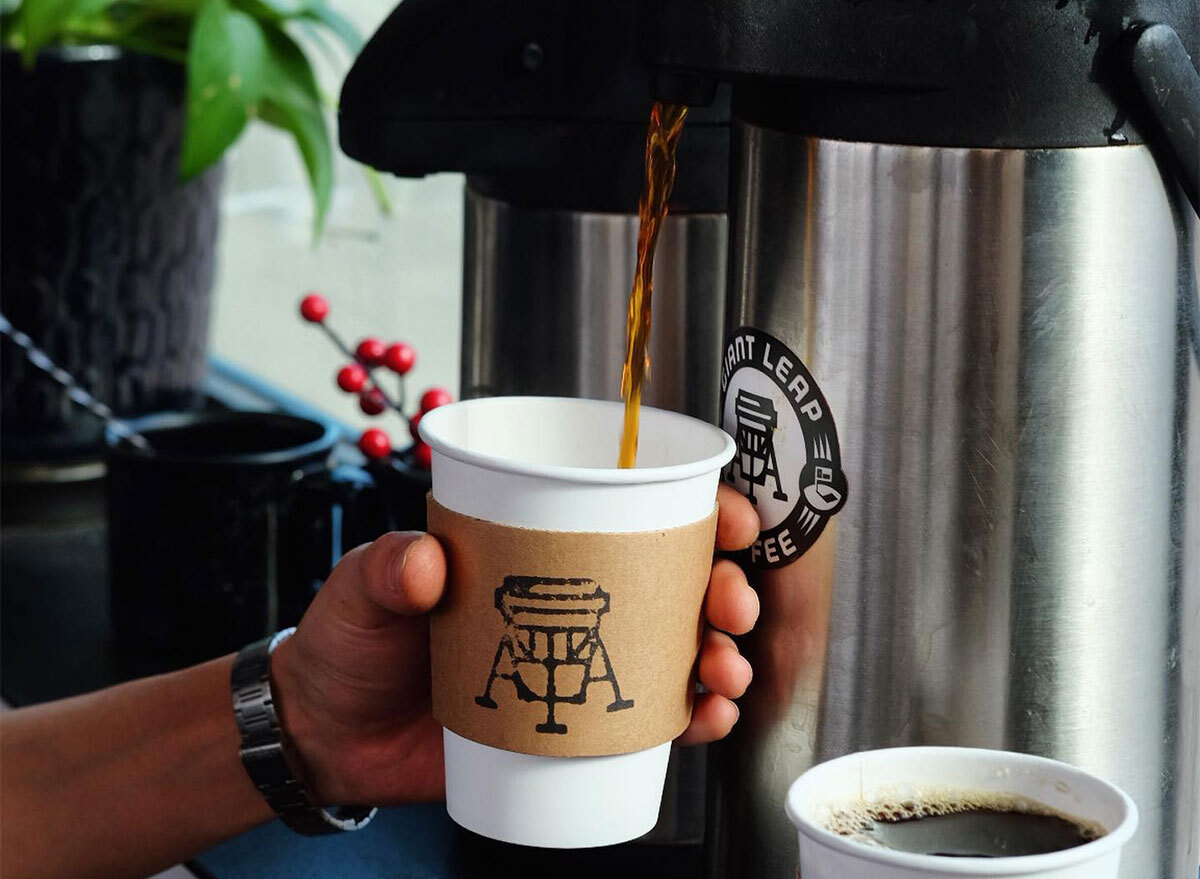 coffee being poured into to go cup