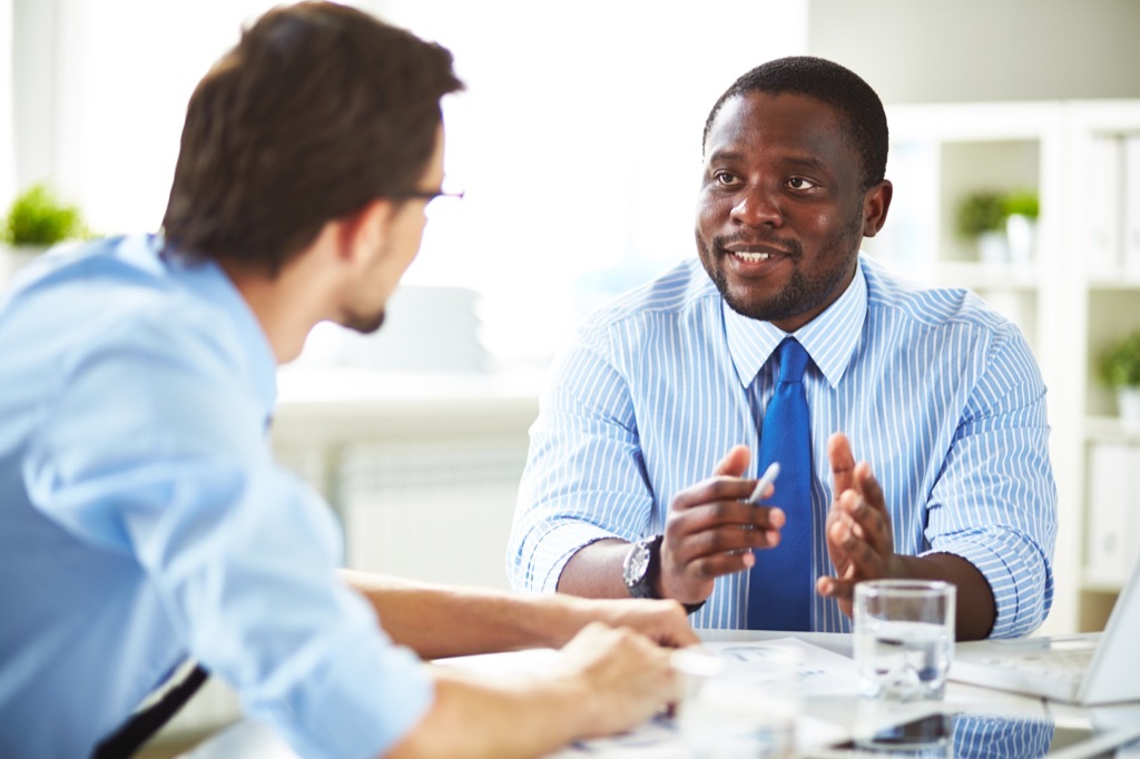 Employees discussing how to improve on an idea.