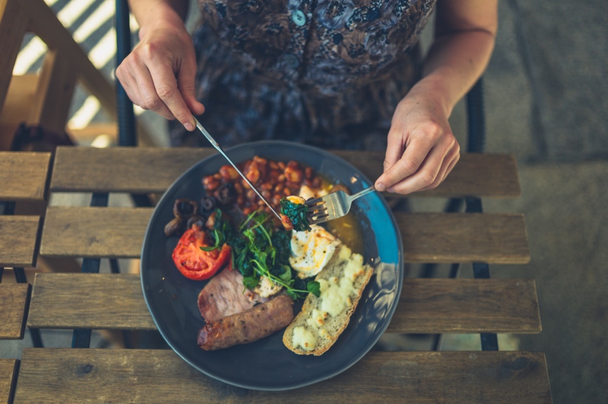 Meal of eggs, steak, bread, beans, and spinach