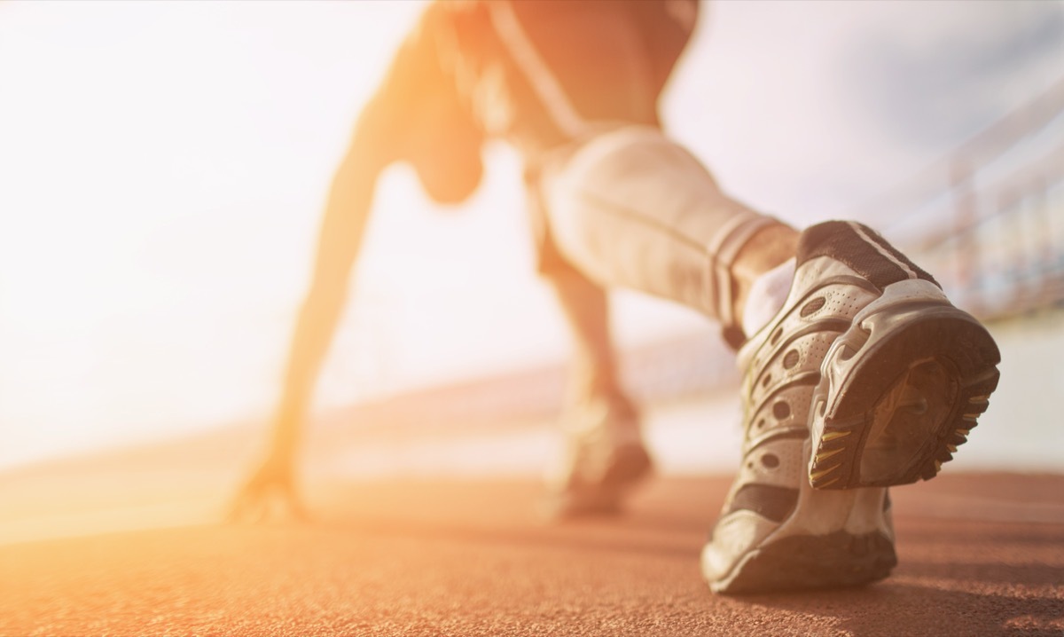 Woman running on a track.