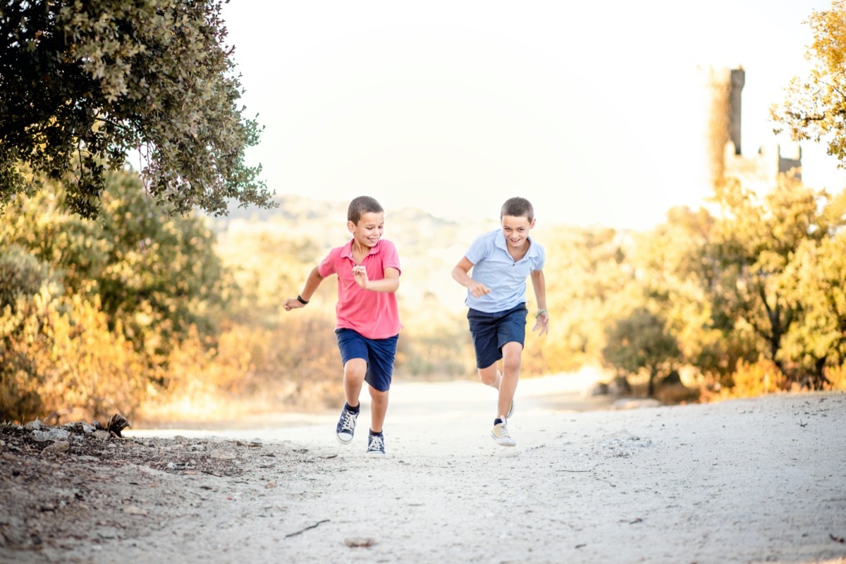 two brothers running into nature