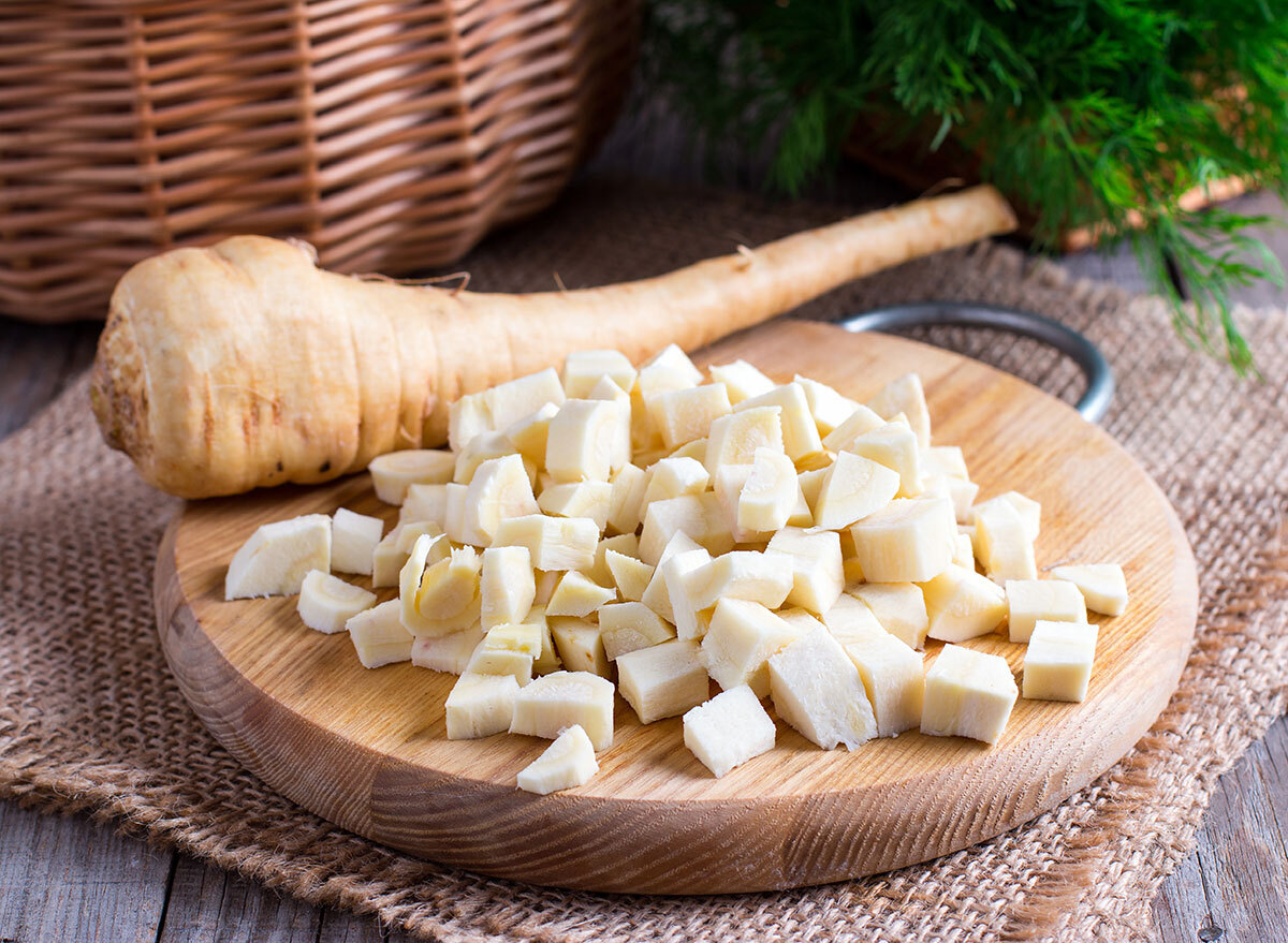 fresh sliced parsnips on wooden board